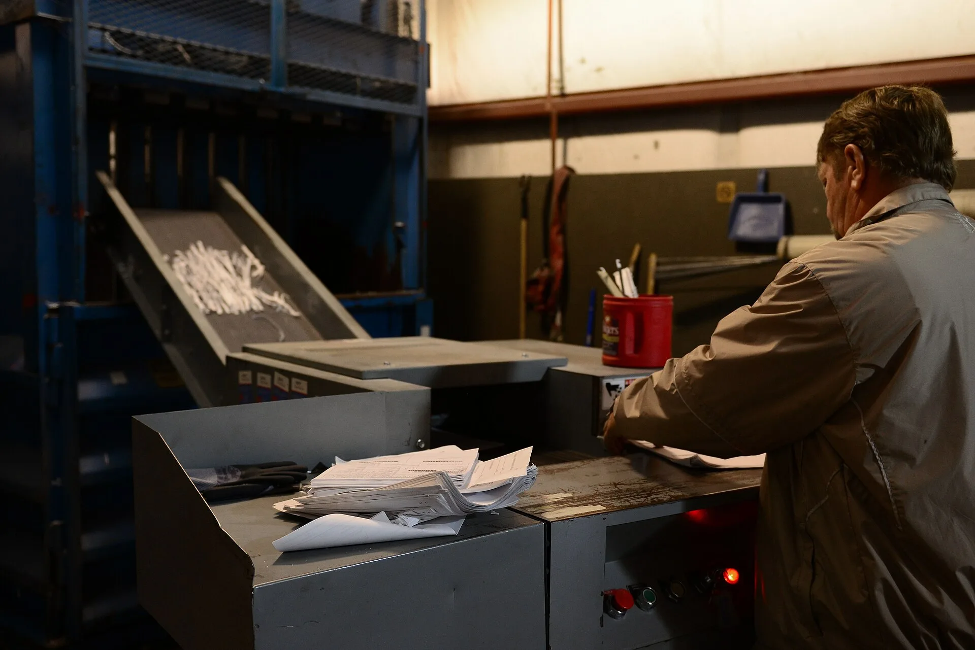 Thomas Gunter, 733rd Civil Engineering Division contracting officer representative, shreds paper at the Solid Waste and Recycle Center at Fort Eustis, Va., May 7, 2014. The SWRC has both a paper shredder and designator for classified and secret documents. Gunter hails from Berwick, Pa. (U.S. Air For