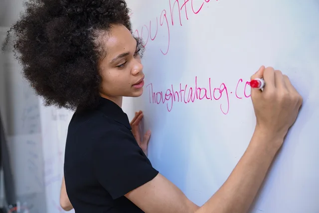 woman, writing, marker, whiteboard, brainstorm, planning, strategy, blue writing, blue plan, blue planning, whiteboard, whiteboard, whiteboard, whiteboard, whiteboard, brainstorm, brainstorm. Setting keyword research team roles without a data ownership gap